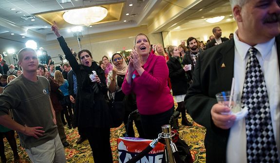 Jill Ward of Richmond, Va., second from right, Nass Era [cq], second from left, visiting from Morocco, cheers as they watch returns on CNN at the Tim Kaine (D) for U.S. Senate election night party at the Richmond Marriott, Richmond, Va., Tuesday, November 6, 2012. (Andrew Harnik/The Washington Times)