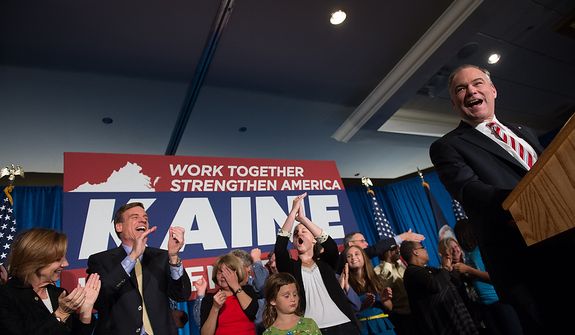 Sen. Mark Warner (D-Va.), second from left, cheers on Tim Kaine (D) as he delivers his victory speech after winning the Virginia election for U.S. Senate at his election night party at the Richmond Marriott, Richmond, Va., Tuesday, November 6, 2012. (Andrew Harnik/The Washington Times)