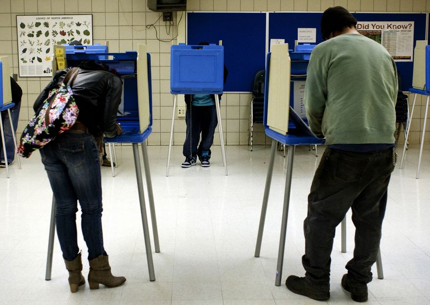 ** FILE ** Voters cast their Election Day ballots on Nov. 6, 2012, in the cafeteria of Handley Elementary School in Saginaw, Mich. (Associated Press/The Saginaw News)