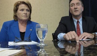 **FILE** Democratic U.S. Senate candidate Heidi Heitkamp (left) listens to Republican opponent Rick Berg speak at a North Dakota Chamber of Commerce forum on health care and energy at a hotel in Bismarck, N.D., on Oct. 11, 2012. (Associated Press)