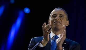 President Obama pauses as he speaks to the cheering crowd at his election-night victory party at McCormick Place in Chicago on Wednesday, Nov. 7, 2012. (AP Photo/Carolyn Kaster)


