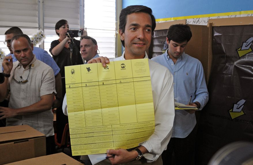 Puerto Rican Gov. Luis Fortuno shows his ballot to the press as he votes at a polling station in Guaynabo, Puerto Rico, on Tuesday, Nov. 6, 2012. (AP Photo/New Progressive Party, Jerry Guillen)