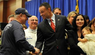 ** FILE ** Republican candidate for the U.S. Senate Dan Bongino shakes hands with a supporter at the Republican election party Tuesday, Nov. 6, 2012, in Linthicum, Md. Also pictured at right is Paula Bongino and Amelia Bongino.(AP Photo/Gail Burton).