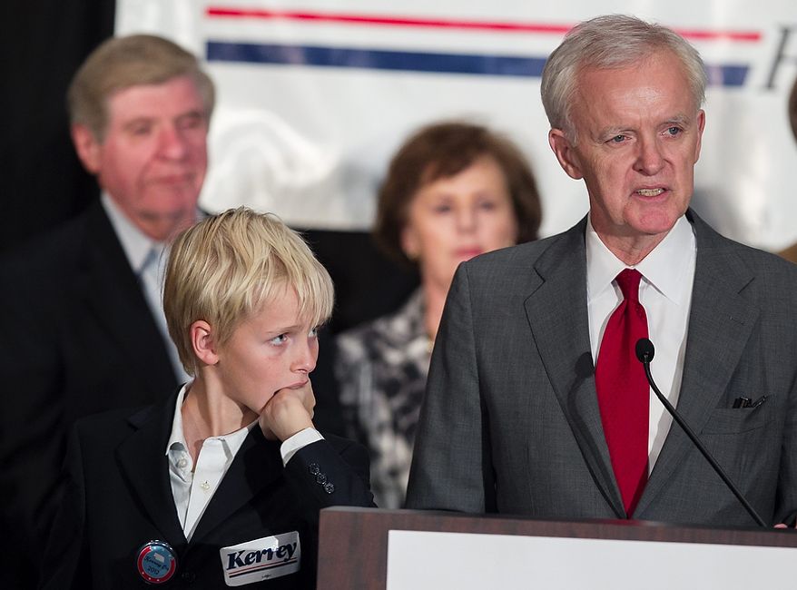 Watched by his son Henry, Democratic Senate candidate Bob Kerrey delivers his concession speech at the Nebraska Democratic Party's election night gathering, in La Vista, Neb., Tuesday, Nov. 6, 2012. Kerrey lost his election bid to Republican Deb Fischer. Rear left is retiring Sen. Ben Nelson, D-Neb. (AP Photo/Nati Harnik)