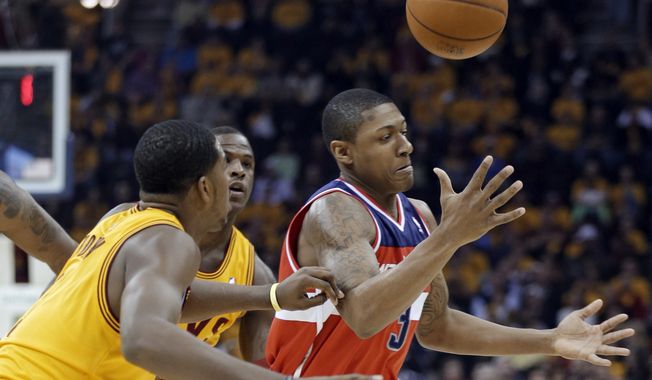 Washington Wizards&#x27; Bradley Beal, right, loses control of the ball under pressure from the Cleveland Cavaliers in the first quarter of an NBA basketball game Tuesday, Oct. 30, 2012, in Cleveland. (AP Photo/Mark Duncan)