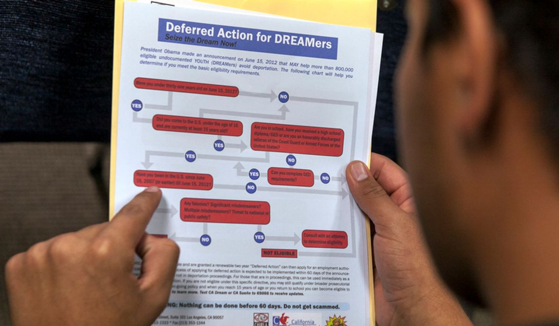 A legal immigrant reads a guide of the conditions needed to apply for the so-called &#x27;DREAMers&#x27; Obama program, formally known as Deferred Action for Childhood Arrivals (DACA), at the Coalition for Humane Immigrant Rights offices in Los Angeles on Aug. 15, 2012. Hundreds of thousands of young illegal immigrants scrambled to get papers in order as the U.S. started accepting applications to allow them to avoid deportation and get a work permit, but not a path to citizenship. (Associated Press) **FILE**
