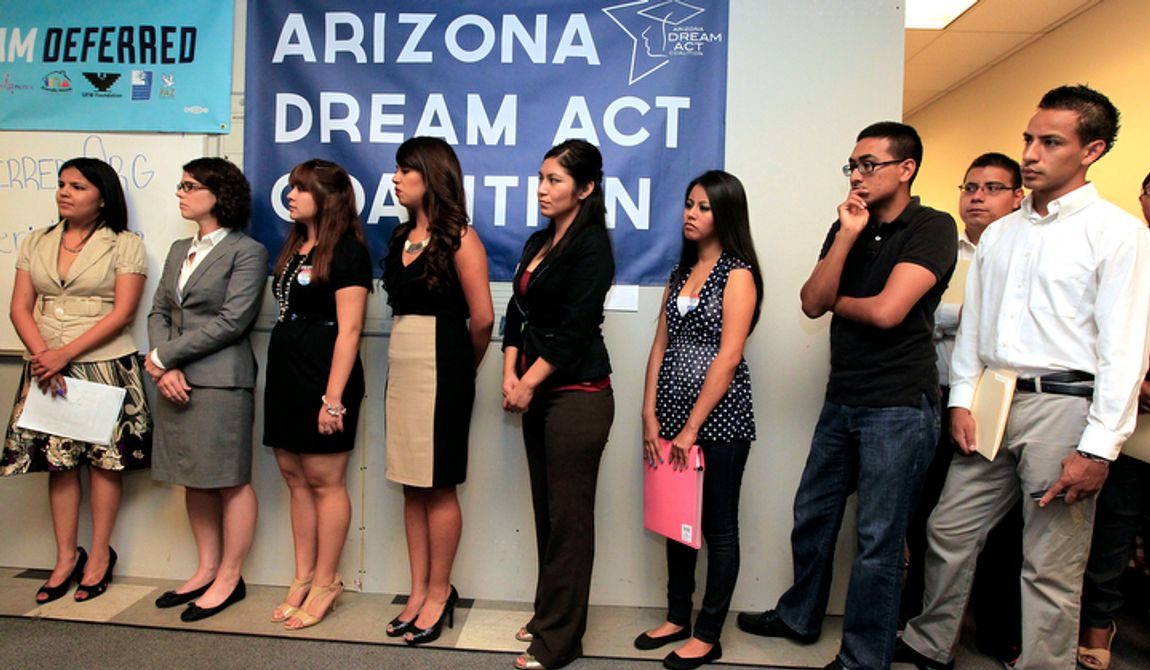 **FILE** Young immigrants, along with members of local immigrant organizations, line up Aug. 15, 2012, in Phoenix for guidance for a new federal program called Deferred Action that would help them avoid deportation. The nationwide program will allow young immigrants to get work permits but not a path to citizenship. (Associated Press)