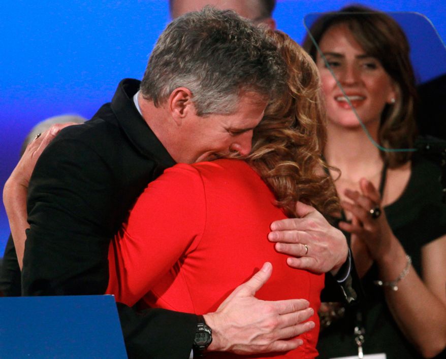 Former U.S. Sen. Scott Brown (left), Massachusetts Republican, hugs his wife, Gail Huff, at the conclusion of his concession speech Nov. 6, 2012, at an Election Night watch party in a hotel in Boston. Brown lost to Democratic challenger Elizabeth Warren in his bid for re-election. (Associated Press)