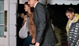 President Obama and daughters Malia (left) and Sasha return to the White House in Washington on Nov. 7, 2012, for the first time since his victory on Election Day. (Associated Press)
