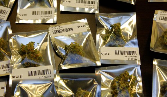 ** FILE ** Medical marijuana is packaged for sale in 1-gram packages at the Northwest Patient Resource Center medical marijuana dispensary in Seattle on Nov. 7, 2012. (Associated Press)