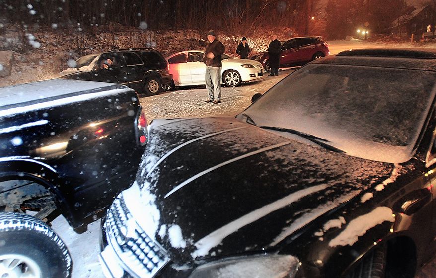 Motorists involved in an 11-car pile-up in Worcester, at the intersection of Chester and West Chester Streets wait for tow trucks and police to arrive, Wednesday, Nov. 7, 2012. Residents from Connecticut to Rhode Island saw 3 to 6 inches of snow on Wednesday. Worcester, Mass., had 8 inches of snow, and Freehold, N.J., had just over a foot overnight. (AP Photo/Worcester Telegram & Gazette, Steve Lanava)