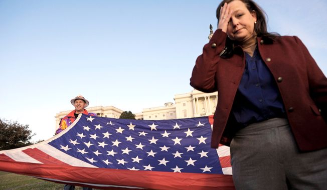 ** FILE ** Tea Party Patriots co-founder Jenny Beth Martin pauses while organizing the start of an Election Day demonstration on the lawn of the Capitol in Washington on Nov. 2, 2010. (Associated Press)