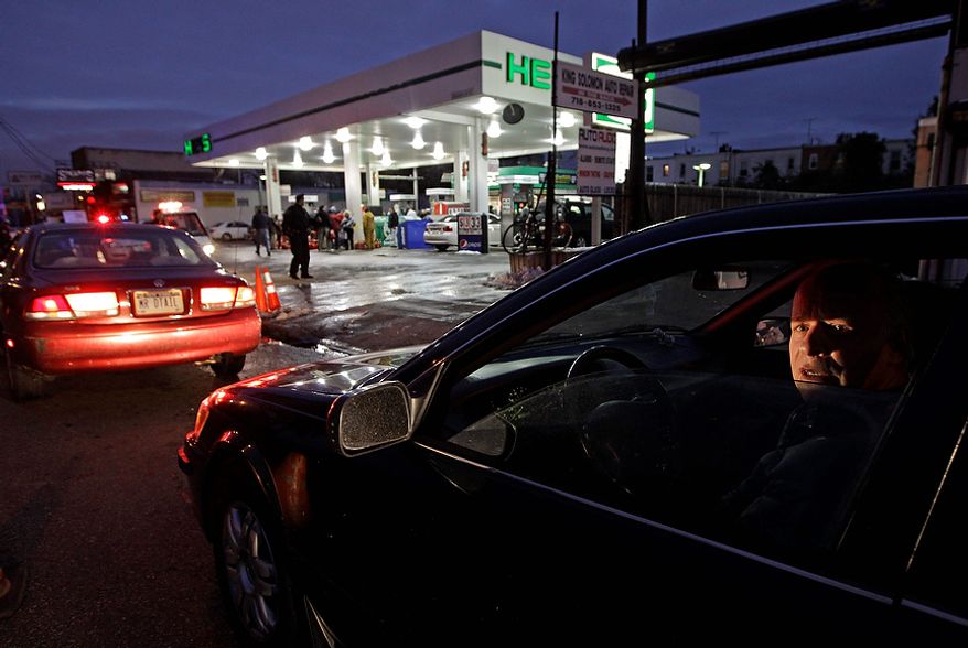 David Kahana, who said he had been sitting on line for one hour and 40 minutes, waits in line to purchase gasoline in the Brooklyn borough of New York on Nov. 8, 2012. Fuel shortages and distribution delays that occurred after Superstorm Sandy and a nor'easter hit the region led to gas hoarding, prompting New York City and Long Island to initiate an even-odd gas rationing plan. (Associated Press)
