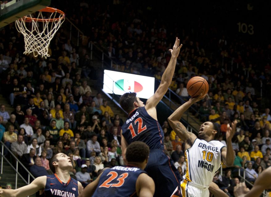 George Mason Patriots guard Sherrod Wright (10) is fouled while attempting a lay up in the first half against the Virginia Cavaliers at the Patriot Center in Fairfax, Va., Wednesday, November 9, 2012. George Mason Patriots host the Virginia Cavaliers for the 2012-2013 men's college basketball season opener. (Craig Bisacre/The Washington Times)