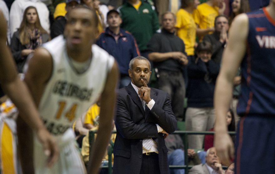 George Mason Patriots head coach Paul Hewitt watches guard Bryon Allen (0) attempt a foul shot in the final second against the Virginia Cavaliers at the Patriot Center in Fairfax, Va., Wednesday, November 9, 2012. George Mason Patriots host the Virginia Cavaliers for the 2012-2013 men's college basketball season opener. (Craig Bisacre/The Washington Times)