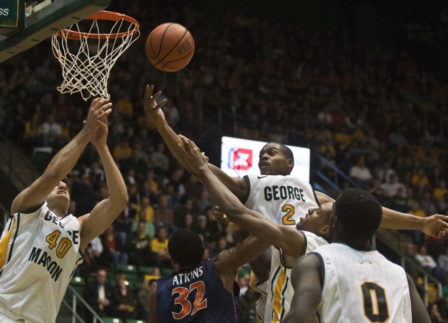 George Mason Patriots forward Johnny Williams (2) and forward Marko Gujanicic (40) attempt to rebound the ball over Virginia Cavaliers forward Darion Atkins (32) in the second half at the Patriot Center in Fairfax, Va., Wednesday, November 9, 2012. George Mason Patriots host the Virginia Cavaliers for the 2012-2013 men's college basketball season opener. (Craig Bisacre/The Washington Times)