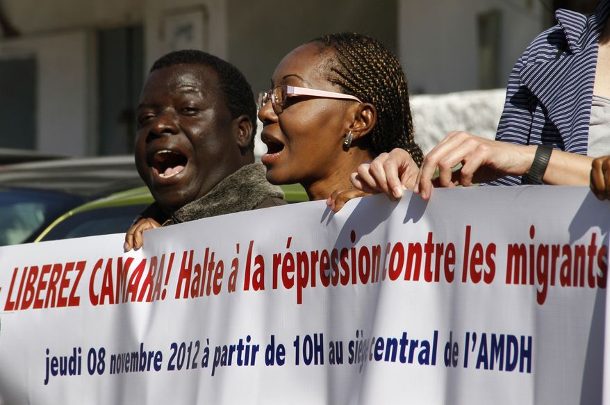 Sadio Balde (left), vice president of the Moroccan Council for Sub-Saharan migrants, joins dozens of Moroccan and foreign activists in a protest Nov. 9, 2012, outside a court in Rabat, Morocco, where Council president Laye Camara is being tried for illegally selling alcohol and cigarettes. Colleagues of Camara say the charges are trumped-up and are part of a widespread crackdown on legal and illegal black African migrants to this North African kingdom that lies just across the narrow Straits of Gibraltar from Europe. (Associated Press)