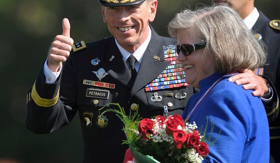 **FILE** Davis Petraeus, former Commander of International Security Assistance Force and U.S. Forces-Afghanistan general, stands with his wife, Holly, as he participates in an Armed Forces farewell tribute and retirement ceremony on Aug. 31, 2011, at Joint Base Myer-Henderson Hall in Arlington, Va. (Associated Press)