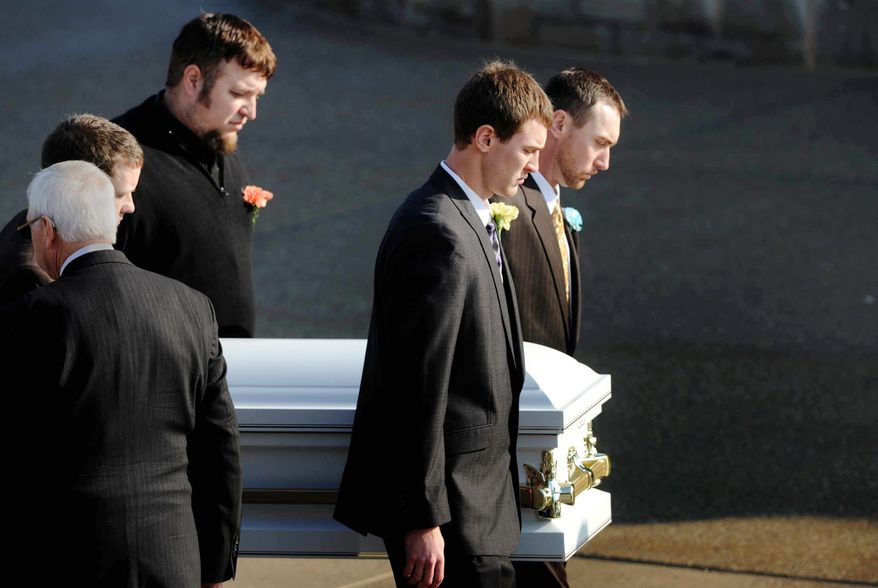 Pallbearers bring the casket of 2-year-old Maddox Derkosh into Saint Bernard Church in Mount Lebanon, Pa., for funeral services on Nov. 9, 2012. Derkosh was killed Nov. 4 after he fell from a wooden railing overlooking the painted dogs exhibit at the Pittsburgh Zoo and PPG Aquarium and bled to death after being mauled by the dogs. (Associated Press/Pittsburgh Post-Gazette, Michael Henninger)