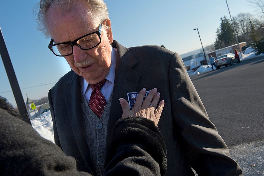 Congressman Roscoe Bartlett gets his "Bartlett for Congress" sticker put on him by his chief of staff outside of Grantsville Elementary School in Grantsville, Md. on Election Day, Tuesday, Nov. 6, 2012. Bartlett, who is in a tight race against Democrat John Delaney, is visiting every county in his district on Election Day. (Barbara L. Salisbury/The Washington Times)