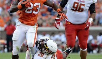 Clemson running back Andre Ellington shakes the tackle of Maryland&#39;s Anthony Nixon while A.J. Francis (96) pursues during the first half of an NCAA college football game Saturday, Nov. 10, 2012, at Memorial Stadium in Clemson, S.C. (AP Photo/Richard Shiro)