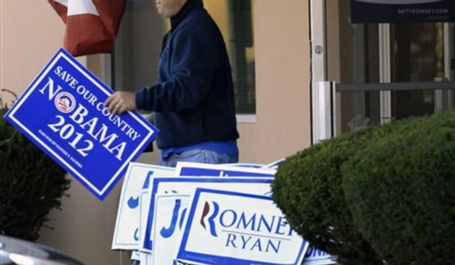 A man walks out of the Ohio headquarters of Mitt Romney campaign office carrying a Nobama 2012 sign, Wednesday, Nov. 7, 2012, in Columbus, Ohio. Romney conceded the presidential election shortly after midnight Wednesday. (AP Photo/Tony Dejak)