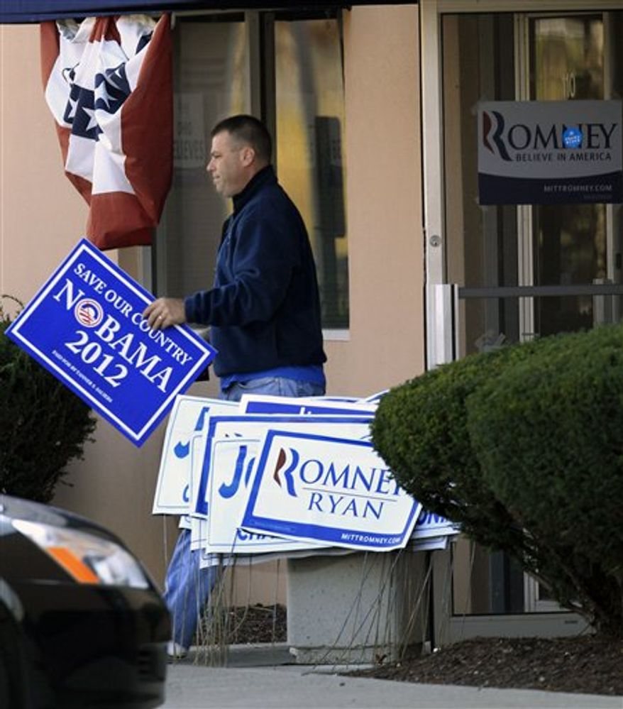 A man walks out of the Ohio headquarters of Mitt Romney campaign office carrying a Nobama 2012 sign, Wednesday, Nov. 7, 2012, in Columbus, Ohio. Romney conceded the presidential election shortly after midnight Wednesday. (AP Photo/Tony Dejak)