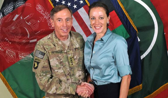 This July 13, 2011, photo made available on the International Security Assistance Force&#39;s Flickr website shows the former Commander of International Security Assistance Force and U.S. Forces-Afghanistan Gen. Davis Petraeus, left, shaking hands with Paula Broadwell, co-author of &quot;All In: The Education of General David Petraeus.&quot;As details emerge about Petraeus&#39; extramarital affair with his biographer, Broadwell, including a second woman who allegedly received threatening emails from the author, members of Congress say they want to know exactly when the now ex-CIA director and retired general popped up in the FBI inquiry, whether national security was compromised and why they weren&#39;t told sooner. (AP Photo/ISAF)