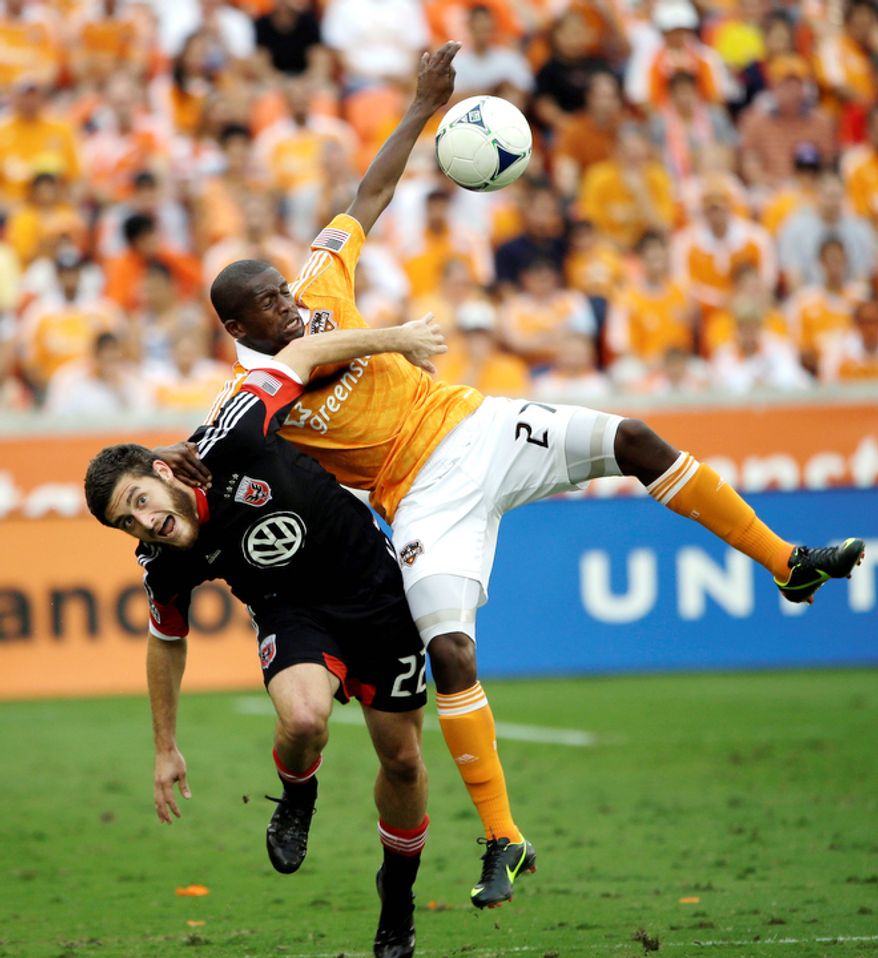 D.C. United's Chris Korb (22) battles Houston Dynamo's Boniek Garcia (27) for the ball during the first half of an MLS Eastern Conference Championship soccer game, Sunday, Nov. 11, 2012, in Houston. (AP Photo/David J. Phillip)