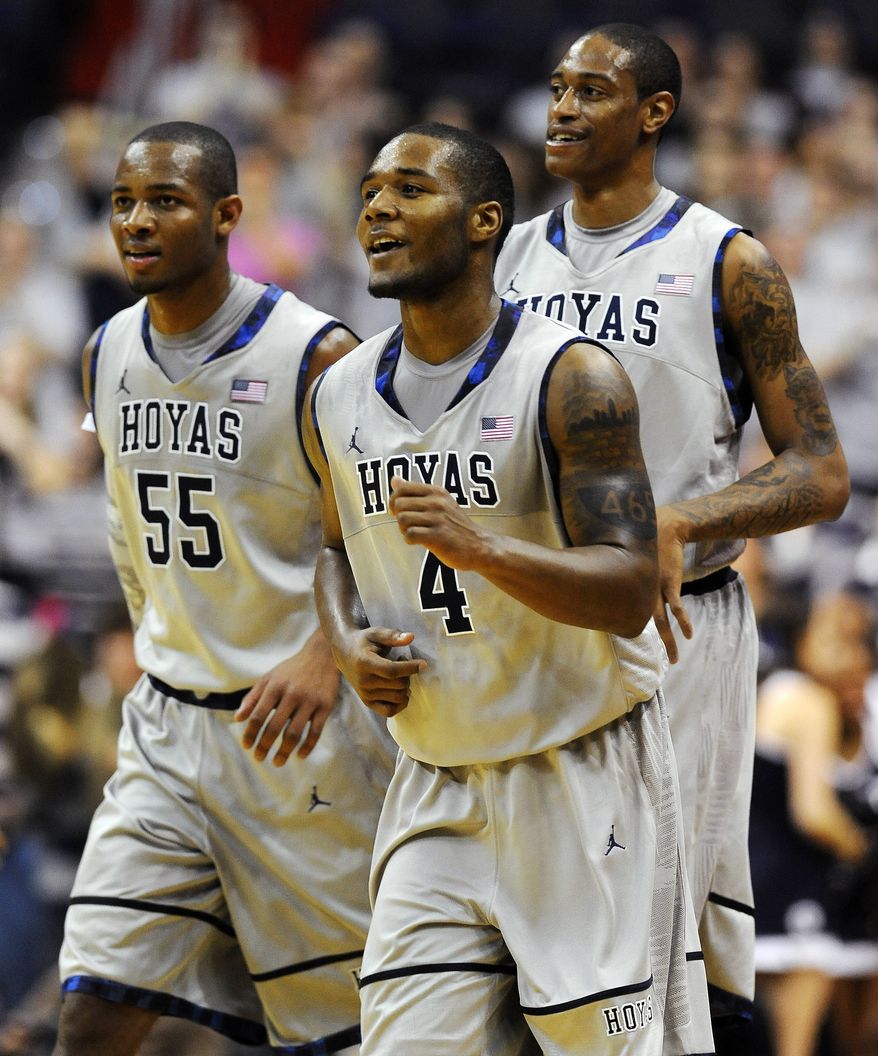 Georgetown guard D'Vauntes Smith-Rivers (4) leaves the court with Jabril Trawick (55) and Greg Whittington during their 61-55 win over Duquesne in their NCAA college basketball game, Sunday, Nov. 11, 2012, in Washington. (AP Photo/Richard Lipski)