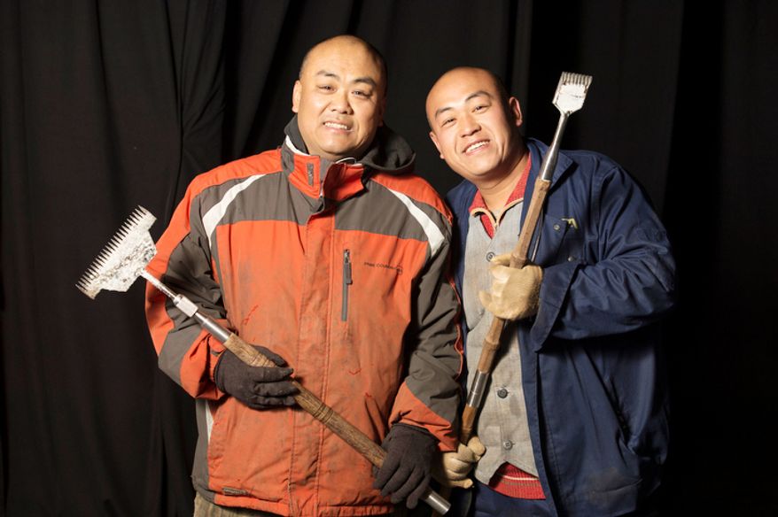 Wang Lian Hai. 39, (left) and his brother Wang Lian Jun, 35, (right) are two of the 40 artisan ice sculptors from Harbin, China, working on the construction of the attraction ICE! featuring DreamWorks Shrek the Halls at the Gaylord National Resort & Convention Center in National Harbor, Md. They are from Harbin, China, the capital city of China's northernmost province, Heilongjiang, across the border from Siberia, Russia. Harbin, China has been host of the Ice and Snow Festival for more than 25 years, welcoming approximately 800,000 visitors annually. (Rod Lamkey Jr./The Washington Times)