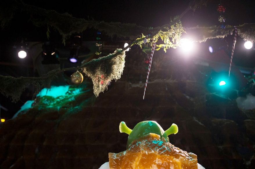 Ice sculptures from the Shrek movies are seen on the big ice slide, under colorful lights in a room temperature of nine degrees, as the artisan ice sculptors from Harbin, China, put the final touches on the attraction ICE! featuring DreamWorks Shrek the Halls at the Gaylord National Resort & Convention Center in National Harbor, Md. (Rod Lamkey Jr./The Washington Times)