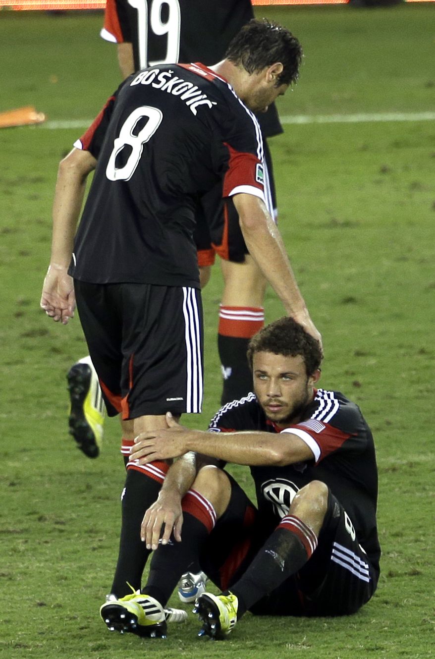 D.C. United's Branko Boskovic (8) pats the head of Nick DeLeon after losing to the Houston Dynamo in an MLS Eastern Conference Championship soccer game, Sunday, Nov. 11, 2012, in Houston. The Dynamo defeated D.C. United 3-1. (AP Photo/David J. Phillip)