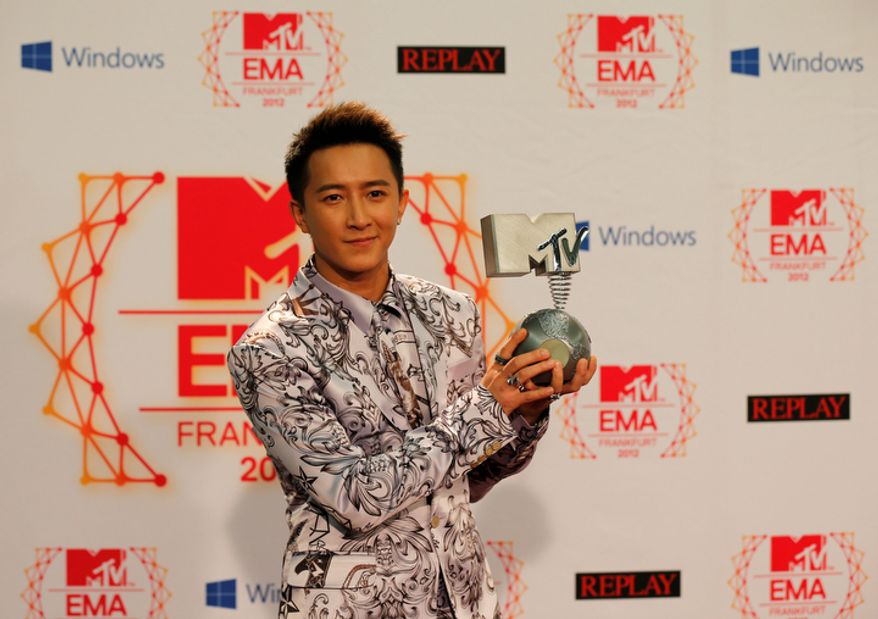 Chinese singer Han Geng presents his award as Best Worldwide Act during the 2012 MTV European Music Awards show at the Festhalle in Frankfurt, central Germany, Sunday, Nov. 11, 2012. (AP Photo/Frank Augstein)