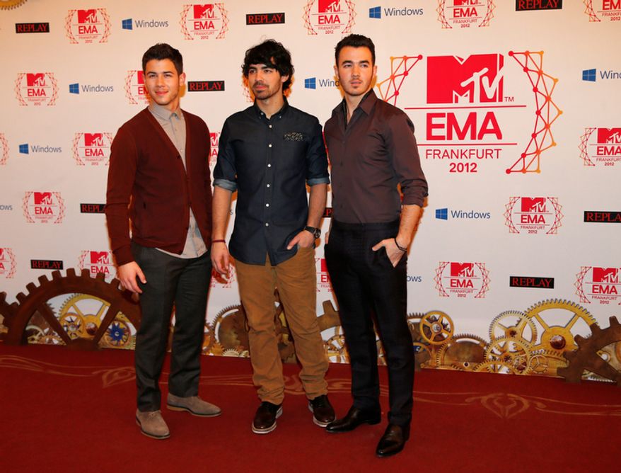The Jonas brothers arrive on the red carpet of the 2012 MTV European Music Awards show at the Festhalle in Frankfurt, central Germany, Sunday, Nov. 11, 2012. (AP Photo/Frank Augstein)