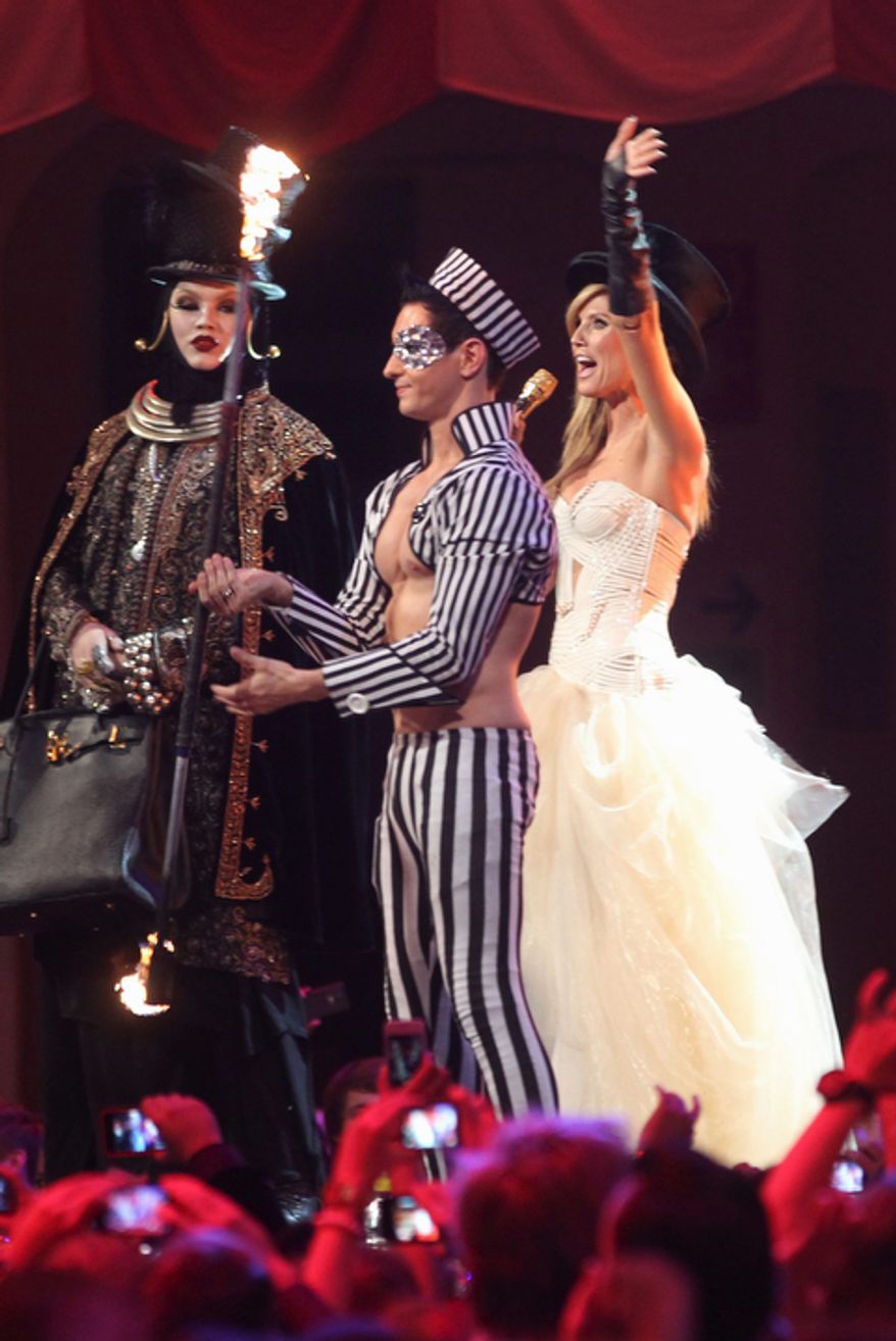 German TV host Heidi Klum, right, appears on stage during the 2012 MTV European Music Awards show at the Festhalle in Frankfurt, central Germany, Sunday, Nov. 11, 2012. (AP Photo/Michael Probst)