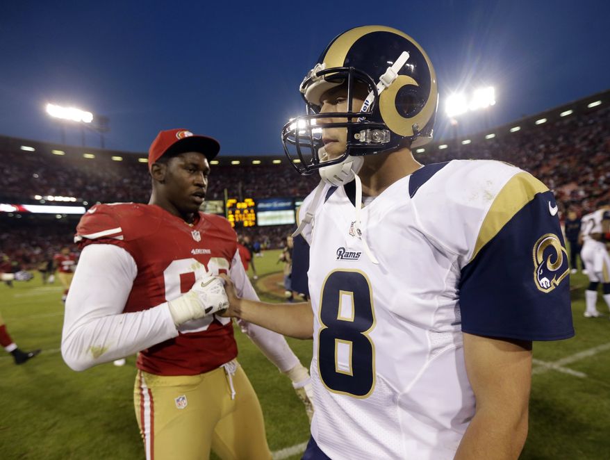 St. Louis Rams quarterback Sam Bradford, right, is greeted by San Francisco 49ers outside linebacker Aldon Smith, left, at the end of their NFL football game in San Francisco, Sunday, Nov. 11, 2012. San Francisco and St. Louis tied their game 24-24. (AP Photo/Marcio Jose Sanchez)