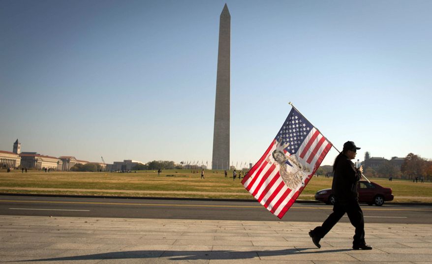 A man walks past the World War II Memorial following the Veterans Day at the National World War II Memorial event in Washington, D.C., Sunday, Nov. 11, 2012. (Rod Lamkey Jr./The Washington Times)