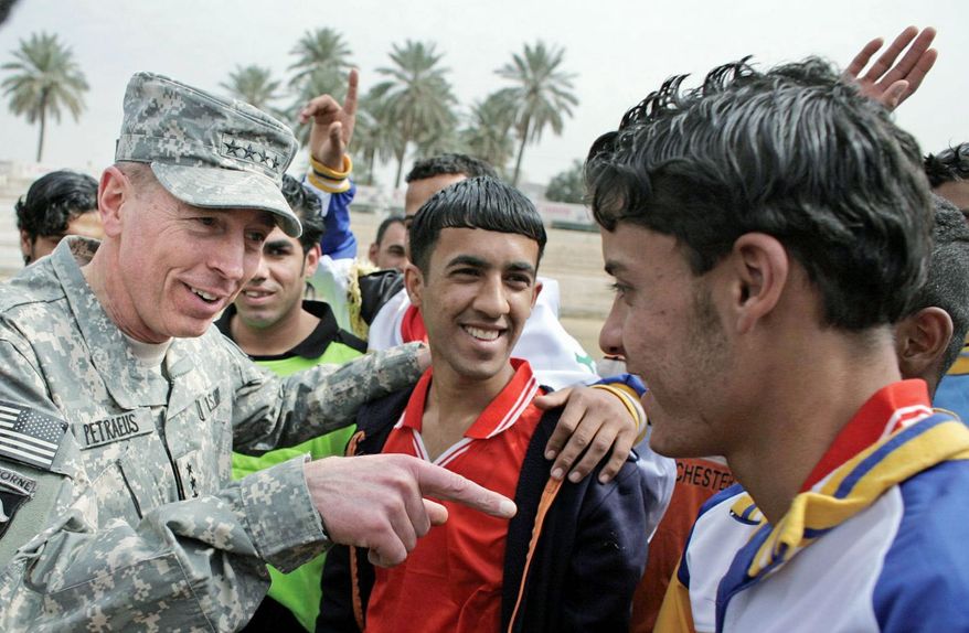 2008: The four-star general visits young soccer players in Baghdad. A central component of his plan was to win over the Iraqi population. (Associated Press)