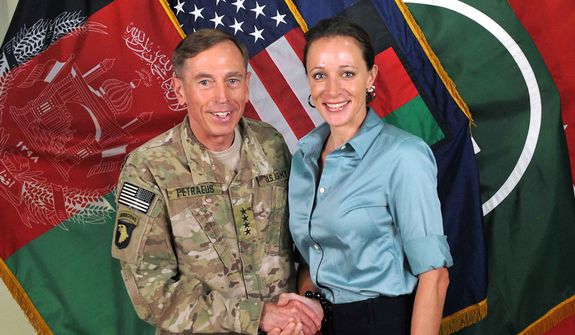 U.S. Army Gen. David H. Petraeus, then-commander of the International Security Assistance Force and U.S. Forces-Afghanistan, shakes hands with Paula Broadwell, co-author of  &quot;All In: The Education of General David Petraeus,&quot; in a July 13, 2011, photo from the ISAF&#39;s Flickr website. (Associated Press/International Security Assistance Force) ** FILE **