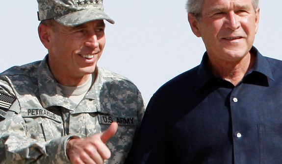 **FILE** President George W. Bush (right) stands with Gen. David Petraeus as he arrives Sept. 3, 2007, for a surprise visit at Al-Asad Airbase in Anbar province, Iraq. (Associated Press)