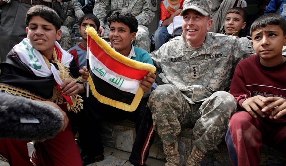 **FILE** Gen. David Petraeus, the top U.S. commander in Iraq, sits March 1, 2008, with Iraqi children during a youth soccer tournament in central Baghdad. (Associated Press)