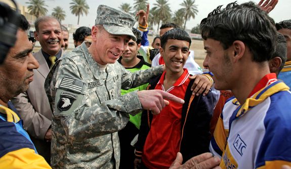 **FILE** Gen. David Petraeus (center left), the top U.S. commander in Iraq, talks March 1, 2008, to players during a youth soccer tournament in central Baghdad. (Associated Press)