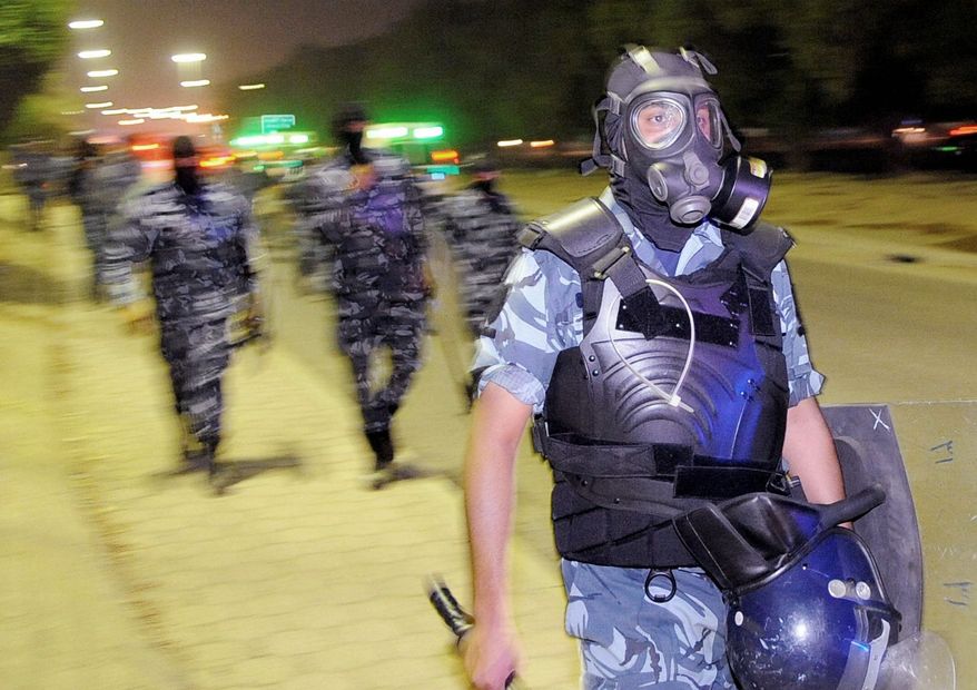 Riot police wield tear gas and stun grenades to disperse a throng of protesters in the Kuwait City suburb of Mishrefs. Strong-armed regimes in the oil-rich Persian Gulf have faced little resistance from Western governments that depend on the region as an energy supplier and as a military deterrent against Iran. (Associated Press)