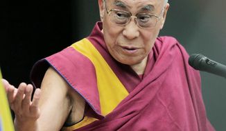 Tibetan spiritual leader the Dalai Lama delivers his speech during a seminar held by Japanese Diet members in Tokyo, Tuesday, Nov. 13, 2012. (Associated Press)