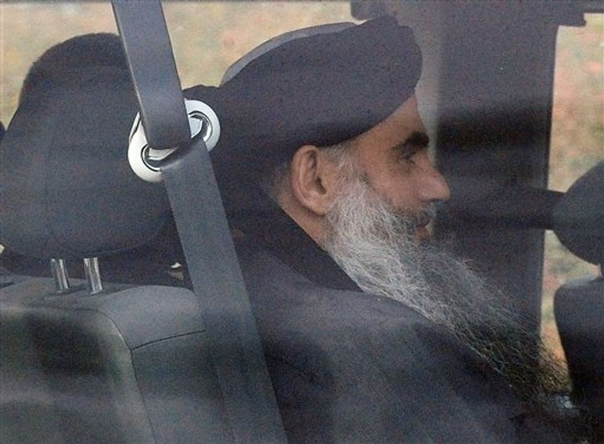 Islamic cleric Abu Qatada is driven out of Long Lartin high security prison in Worcestershire, England, after winning the latest round in his battle against deportation, Tuesday Nov. 13, 2012. British authorities say radical Islamist cleric Abu Qatada has been freed from prison after a court ruled he cannot be deported from Britain to Jordan to face terrorism charges. (AP Photo/ Rui Vieira/PA)