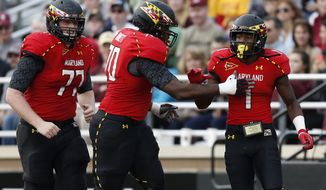 Maryland wide receiver Stefon Diggs (1) celebrates his touchdown with teammates Mike Madaras (77) and De&#39;Onte Arnett (70)in the fourth quarter of an NCAA college football game against Boston College in Boston, Saturday, Oct. 27, 2012. Boston College won 20-17. (AP Photo/Michael Dwyer)