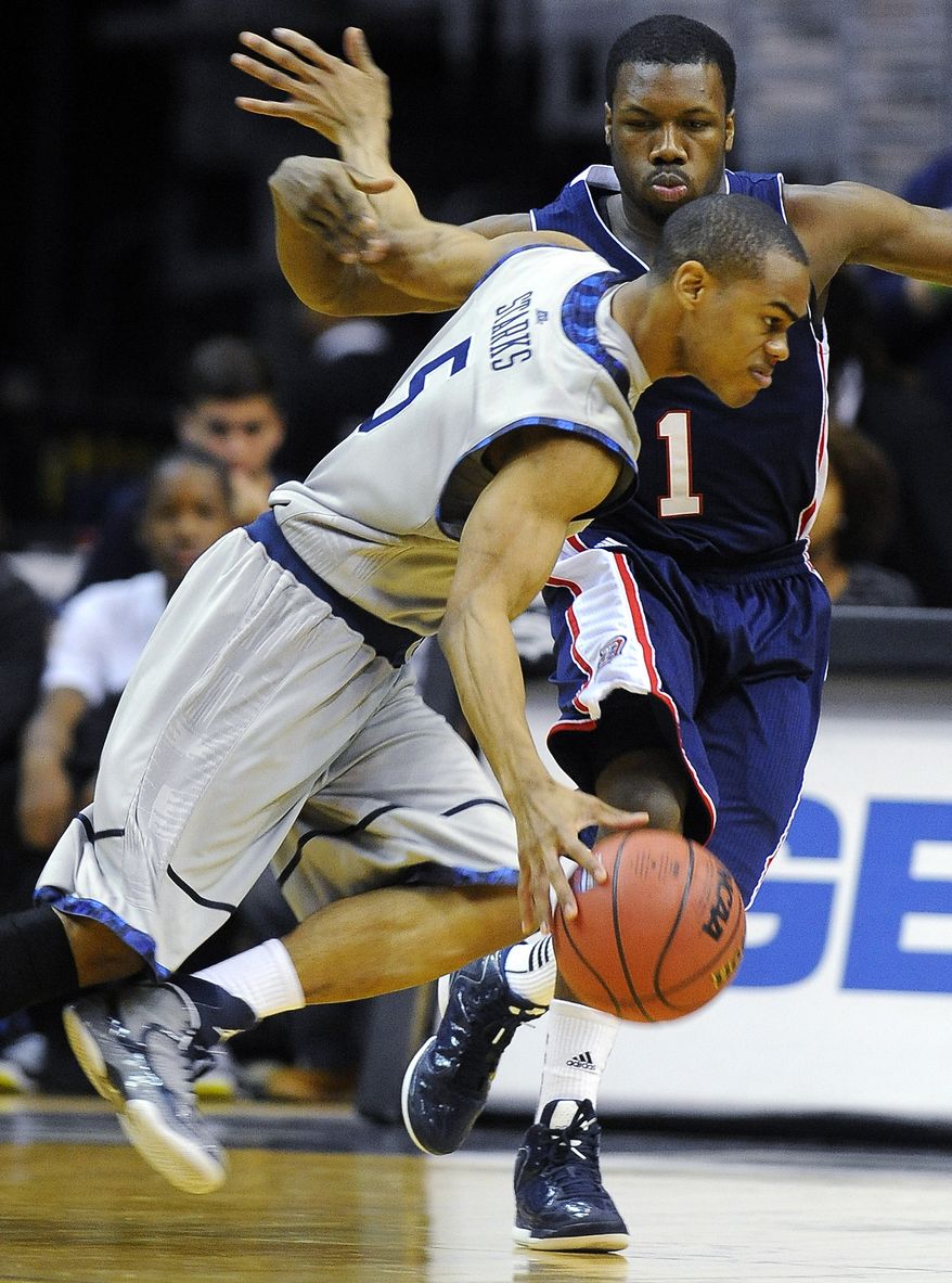 Duquesne's Derrick Colter (1) tries to defend against Georgetown's Markel Starks (5) during their NCAA college basketball game, Sunday, Nov. 11, 2012, in Washington. Georgetown won 61-55. (AP Photo/Richard Lipski)