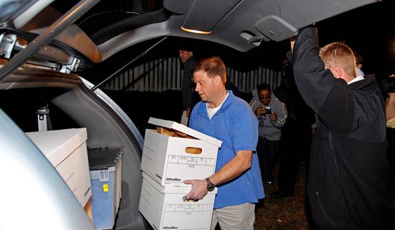 FBI agents carry boxes from the home of Paula Broadwell, the woman whose affair with retired Gen. David Petraeus led to his resignation as CIA director, in the Dilworth neighborhood of Charlotte, N.C., on Nov. 13, 2012. (Associated Press)