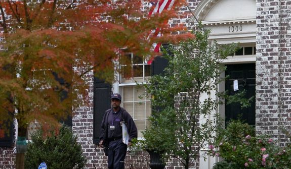 A FedEx driver leaves after trying to deliver a package to the home of Paula Broadwell, the woman whose affair with retired Gen. David Petraeus led to his resignation as CIA director, in the Dilworth neighborhood of Charlotte, N.C., on Nov. 12, 2012. FBI agents later appeared at Broadwell&#39;s home carrying the kinds of cardboard boxes often used for evidence gathering during a search. A spokeswoman for the FBI declined to say what the agents were doing there. (Associated Press/The Charlotte Observer)